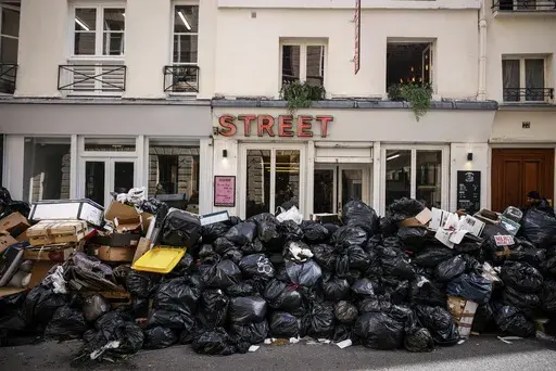 Uncollected garbage is piled up on a street in Paris, March 15, 2023, during an ongoing strike by sanitation workers. (AP Photo/Thomas Padilla, File)
