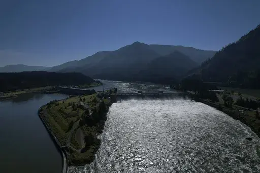 Water spills over the Bonneville Dam on the Columbia River, which runs along the Washington and Oregon state line, on Tuesday, June 21, 2022. The U.S. government on Tuesday, June 18, 2024, acknowledged for the first time the harms that the construction and operation of dams on the Columbia and Snake rivers in the Pacific Northwest have caused Native American tribes, issuing a report that details how the unprecedented structures devastated salmon runs, inundated villages and burial grounds, and c