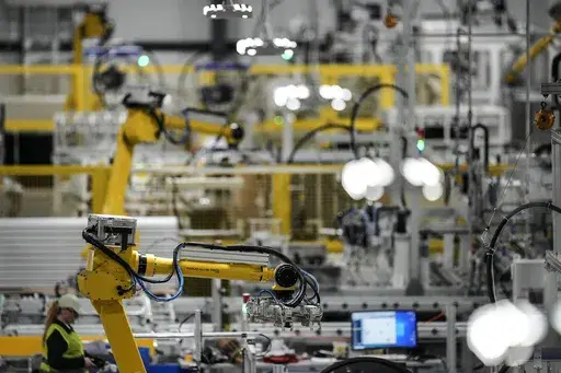 Articulated robots move inside the Hanwha Qcells Solar plant, Oct. 16, 2023, in Dalton, Ga. On Thursday, April 25, 2024, the U.S. government issues the first of three estimates of economic growth in the first quarter. (AP Photo/Mike Stewart, File)