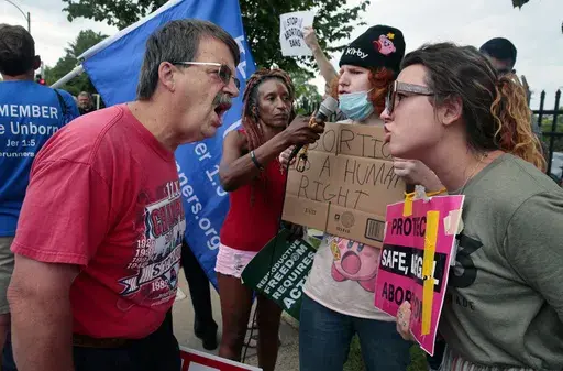 Steve Sallwasser, of Arnold, debates Brittany Nickens, of Maplewood, during competing rallies outside Planned Parenthood of Missouri, following the U.S. Supreme Court decision to overturn Roe v. Wade, June 24, 2022, in St. Louis. (Robert Cohen/St. Louis Post-Dispatch via AP, File)