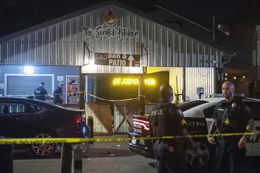 Crime scene tape surrounds The Scratch Kitchen restaurant after a shooting during a Cinco de Mayo party late Friday, May 5, 2023, in Ocean Springs, Miss. (Hannah Ruhoff/The Sun Herald via AP)