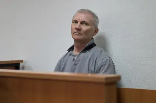 Alexei Moskalyov sits in a courtroom in Yefremov, Tula region, some 300 kilometers (186 miles) south of Moscow, Russia, Monday, March 27, 2023. A court in Russia on Tuesday convicted a single father over social media posts criticizing the war in Ukraine and sentenced him to two years in prison — a case brought to the attention of authorities by his daughter's drawings against the invasion at school, according to the man's lawyer and local activists. The 54-year-old Moskalyov, a single father o