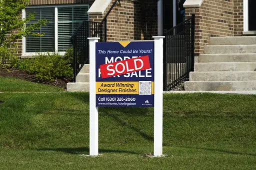 An advertising sign for building land stands in front of a new home construction site in Northbrook, Ill., Wednesday, Sept. 21, 2022.  Elevated home prices, rising interest rates and steep competition are interrupting millennials’ plans to get that quintessential piece of the American dream — their first home, or an upgrade from a small starter home. If you were planning on buying a home over the past year or so, you may have started the process by getting a mortgage preapproval and working 