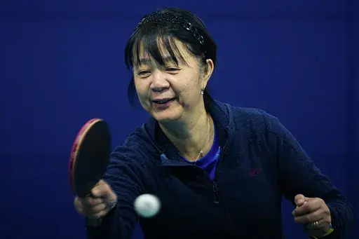 Table tennis player Zhiying Zeng trains at the National Olympic Training Center in Santiago, Chile, Wednesday, June 26, 2024. Born in China and nationalized Chilean, Zeng took a three-decade break from the sport before winning a bronze medal at the 2023 Pan American Games and will be the oldest athlete representing Chile at the 2024 Paris Olympics. (AP Photo/Esteban Felix)