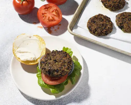 This image released by Milk Street shows a recipe for quinoa and black bean burgers. (Milk Street via AP)
