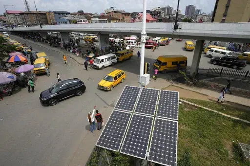 Solar panels sit near a street in the Obalende neighborhood of Lagos, Nigeria, Saturday, Aug. 20, 2022. Access to more and cleaner energy while continuing to grow economically will be a top priority for African nations in the upcoming United Nations climate conference in November, top officials and climate experts on the continent said. (AP Photo/Sunday Alamba)