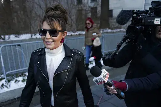 Former Alaska Gov. Sarah Palin leaves a courthouse in New York, Monday, Feb. 14, 2022. A judge said Monday he’ll dismiss a libel lawsuit that Palin filed against The New York Times, claiming the newspaper damaged her reputation with an editorial falsely linking her campaign rhetoric to a mass shooting. U.S. District Judge Jed Rakoff made the ruling with a jury still deliberating in the trial where the former Alaska governor and vice-presidential candidate testified last week. (AP Photo/Seth We