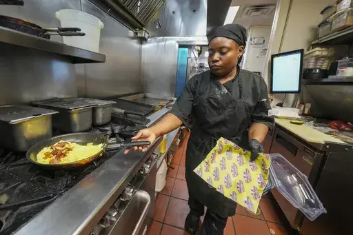 Johkiya Pierre prepares a fresh omelette at The Breakfast Brothers restaurant, Wednesday, Feb. 12, 2025, in Arlington, Texas. (AP Photo/Julio Cortez)