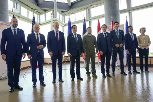 President Joe Biden, third from left, and Ukrainian President Volodymyr Zelenskyy, center, and other G7 leaders pose for a photo before a working session on Ukraine during the G7 Summit in Hiroshima, Japan, Sunday, May 21, 2023. Other leaders from right to left, European Commission President Ursula von der Leyen, Britain's Prime Minister Rishi Sunak, Canada's Prime Minister Justin Trudeau, France's President Emmanuel Macron, Zelenskyy, Japan's Prime Minister Fumio Kishida, Biden, German Chancell