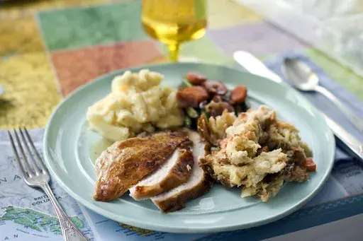 A plate of roasted turkey and gravy, stuffing, mashed potatoes, and glazed carrots appears in Concord, N.H., on Oct. 2, 2012. The Associated Press-NORC Center for Public Affairs Research looks at the state of the country's Thanksgiving favorites. (AP Photo/Matthew Mead, File)