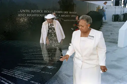 Mamie Till-Mobley, mother of lynching victim Emmett Till, right, and Wilma Allen, of New Orleans, search for their relatives' names on the black granite table at the Civil Rights Memorial in Montgomery, Ala., Nov. 5, 1989. A memorial honoring Till-Mobley will be unveiled Saturday, April 29, 2023, outside the suburban Chicago high school she attended as a young woman, long before she became a critical player in the Civil Rights Movement. (AP Photo/Dave Martin, File)