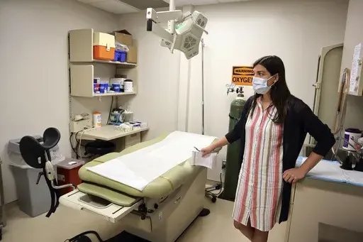 Chief Nurse Executive Danielle Maness stands in an empty examination room that was used to perform abortions at the Women's Health Center of West Virginia in Charleston, W.Va., June 29, 2022. A new abortion provider, the Women’s Health Center of Maryland, is opening this year in the Democratic-controlled state — just across from deeply conservative West Virginia, where state lawmakers recently passed a near-total abortion ban. (AP Photo/Leah Willingham, File)