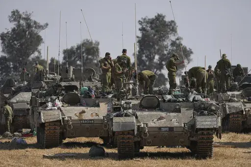 Israeli soldiers are seen at a staging ground near the border with the Gaza Strip, in southern Israel, Tuesday, April 30, 2024. (AP Photo/Tsafrir Abayov)