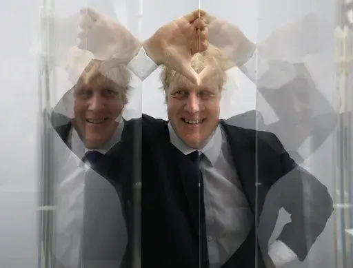 Boris Johnson, then Mayor of London looks through perspex as models of the next two commissions that will appear on the fourth plinth in Trafalgar Square are unveiled, in London, Friday, Jan. 14, 2011. He was the mayor who reveled in the glory of hosting the 2012 London Olympics, and the man who led the Conservatives to a whopping election victory on the back of his mission to “get Brexit done.” But Boris Johnson’s time as prime minister was marred by his handling of the coronavirus pandem