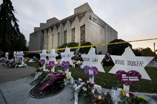 A makeshift memorial stands outside the Tree of Life Synagogue in the aftermath of a deadly shooting in Pittsburgh, Oct. 29, 2018. The man charged in the deadliest antisemitic attack in U.S. history has for years been trying unsuccessfully to avoid having a federal jury decide whether to convict him of shooting to death 11 people during services in a Pittsburgh synagogue, a trial scheduled to get underway with jury selection in less than two weeks. (AP Photo/Matt Rourke, File)