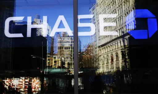 A Chase bank branch is seen through glass on Jan. 11, 2016, in New York. An unexplained outage at Chase Bank Tuesday, July 25, 2023, has led to interruptions for users of the Zelle payment network, who took to social media to complain. (AP Photo/Mark Lennihan, File)