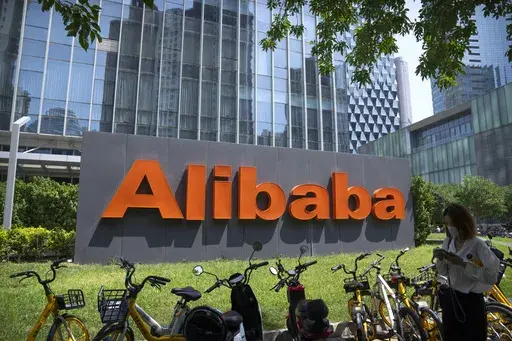 The logo of Chinese technology firm Alibaba is seen at its office in Beijing on Aug. 10, 2021. Alibaba Group Holding on Thursday, May 18, 2023 said that it plans to spin-off of its cloud computing unit and that its logistics and grocery units would begin exploring initial public offerings, as the e-commerce firm kickstarts a restructuring process of its businesses aimed at spurring growth. (AP Photo/Mark Schiefelbein, File)