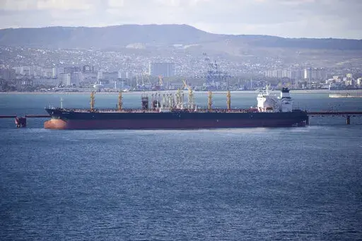 An oil tanker is moored at the Sheskharis complex, part of Chernomortransneft JSC, a subsidiary of Transneft PJSC, in Novorossiysk, Russia, on Oct. 11, 2022. A Russian official says the country will will cut oil production by 500,000 barrels per day next month in response to the West capping the price of its crude over the war in Ukraine. According to multiple Russian news media reports, Deputy Prime Minister Alexander Novak said Friday, Feb. 10, 2023 that “we will not sell oil to those who di