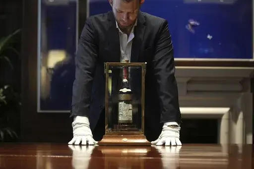 A view of a bottle of Macallan Adami 1926 whisky, on display during a media preview at Sotheby's auction house, in London, Thursday, Oct. 19, 2023. A bottle of Scotch whisky billed as “the most sought-after” in the world sold on Saturday, Nov. 18, 2023 for almost 2.2 million pounds ($2.7 million), an auction record for a bottle of wine or spirits. The Macallan Adami 1926 sold at Sotheby’s in London, after a bidding war between would-be buyers on the phone and in the room. (AP Photo/Kin Che