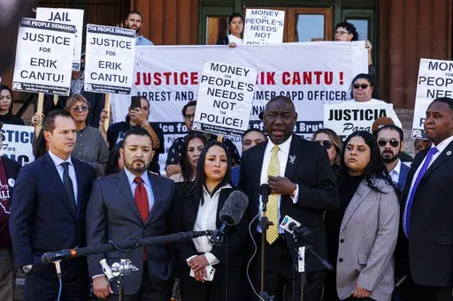 Attorney Benjamin Crump, third from right, addresses the media alongside 17-year-old Erik Cantu's family during a press conference held to update the public about his current medical condition in front of the Bexar County Courthouse in San Antonio, Tuesday, Oct. 25, 2022. Cantu was shot multiple times by former San Antonio police officer James Brennand  on Oct. 2. (Sam Owens/The San Antonio Express-News via AP)