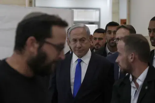 Israeli Prime Minister Benjamin Netanyahu, center, arrives at the District Court in Jerusalem, Israel, Sunday, June 25, 2023. Hollywood producer Arnon Milchan was testifying Sunday at Netanyahu’s corruption trial to answer questions about an alleged “supply line” of champagne and cigars funneled to the Israeli leader and his wife said to have been in exchange for help with Milchan’s personal and business needs. Milchan appeared by videoconference from the English city of Brighton. (Atef 