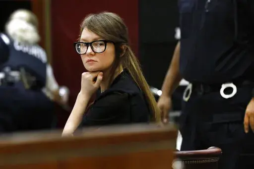 FILE — Anna Sorokin sits at the defense table during jury deliberations in her trial at New York State Supreme Court, April 25, 2019, in New York. Sorokin, the convicted swindler who claimed to be a German heiress to finance a posh lifestyle in New York, is making a new bid to fight deportation, her lawyer said Tuesday, March 15, 2022. (AP Photo/Richard Drew, File)