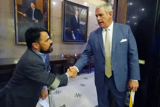 As is his tradition, House Speaker Philip Gunn, R-Clinton, right, shakes the hand and says goodbye to each lawmaker, such as Rep. Shane Aguirre, R-Tupelo, at the conclusion of the legislative session at the Mississippi Capitol in Jackson, Tuesday, April 5, 2022. (AP Photo/Rogelio V. Solis)