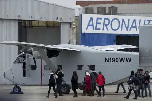 Members of human rights organizations walk alongside one of the planes that carried out "death flights," when detainees were tossed out into the sea during Argentina's last military dictatorship, on the tarmac of the Jorge Newbery international airport in Buenos Aires, Argentina, Saturday, June 24, 2023. The plane that had been located in the US arrived in Argentina's capital Saturday and will eventually be transferred to the the Museum of Memory set up in the former illegal detention center kno