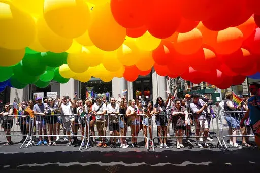 Spectators watch as revelers march down Fifth Avenue during the annual NYC Pride March, Sunday, June 26, 2022, in New York. (AP Photo/Mary Altaffer)