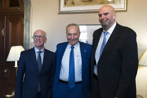 Senate Majority Leader Chuck Schumer, D-N.Y., center, welcomes Senator-elect Peter Welch, D-Vt., left, and Senator-elect John Fetterman, D-Pa., whose victories helped give Democrats the majority in the next Congress, at the Capitol in Washington, Tuesday, Nov. 15, 2022. (AP Photo/J. Scott Applewhite, File)