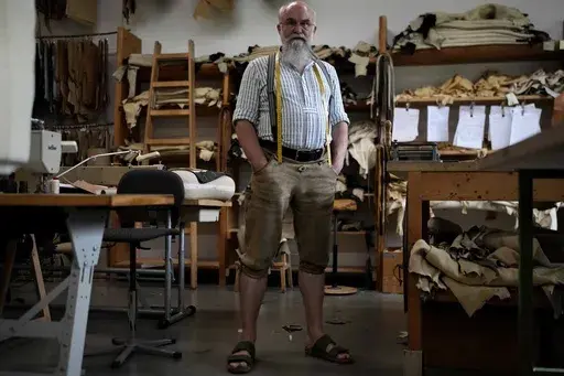 Saddler Klaus Bensmann works in his store in Bad Hindelang, Germany, Wednesday, Sept. 13, 2023. Bensmann produces tailored leather trousers and vests with hand embroidery. The leather comes from the alpine region and is tanned in Germany. For the upcoming Oktoberfest, many visitors like to wear the traditional dress. The 189th Oktoberfest, the world's biggest beer festival, runs from Sept. 16 through Oct. 3, 2023.(AP Photo/Matthias Schrader)