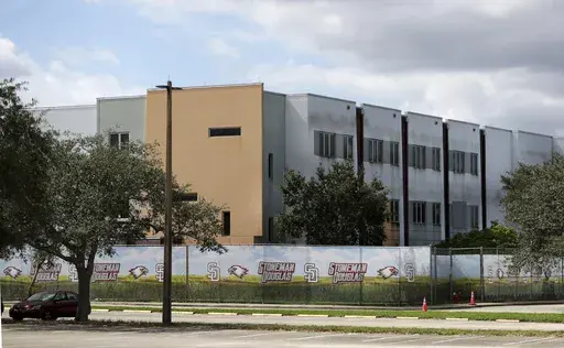 The 1200 building at Marjory Stoneman Douglas High School in Parkland, Fla., is seen, Oct. 20, 2021. The school building where 14 students and three staff members were fatally shot in a 2018 massacre is set to be demolished next summer, officials announced Thursday, Sept. 21, 2023. The demolition of Marjory Stoneman Douglas High School’s 1200 building, which has remained closed and locked behind a fence since the shooting, is scheduled to take place immediately following the conclusion of the 