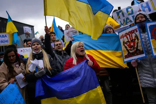 Pro-Ukrainian people wave Ukrainian flags as they shout slogans during a protest against Russia's invasion of Ukraine, in Istanbul, Turkey, Tuesday, March 1, 2022. Russia's military assault on Ukraine is now in its sixth day. A miles-long convoy of Russian tanks and armored vehicles is inching closer to the Ukrainian capital and fighting has intensified on the ground as Russia stepped up shelling of Kharkiv, Ukraine’s second-largest city. (AP Photo/Francisco Seco)