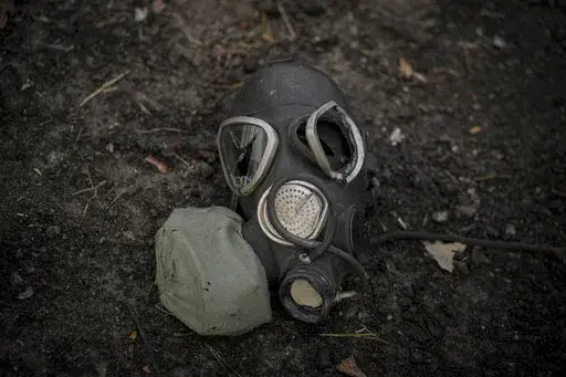 A damaged gas mask lies on the pavement at a Russian position which was overran by Ukrainian forces, outside Kyiv, Ukraine, March 31, 2022. Russia’s assault on Ukraine and its veiled threats of using nuclear arms have policymakers questioning how the West should respond to a Russian battlefield explosion of a nuclear bomb. The default U.S. policy answer, say some architects of the post-Cold War nuclear order, is with discipline and restraint. (AP Photo/Vadim Ghirda, File)