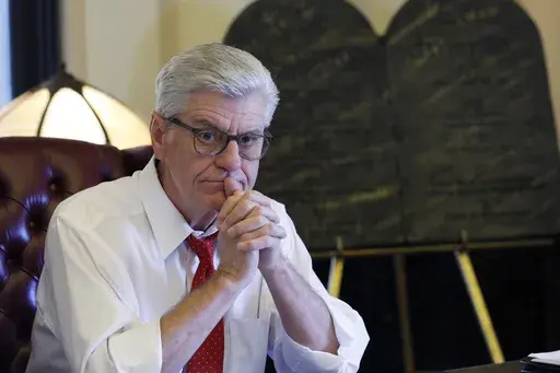 Mississippi Gov. Phil Bryant ponders a response to a question regarding his legacy following a life of public service, Jan. 8, 2020, while sitting in his Jackson, Miss., Capitol office. On Wednesday, July 26, 2023, the former Mississippi governor filed suit against a local news organization, claiming it defamed him in public comments on the misspending of $77 million of federal welfare funds intended to help some of the poorest people in the U.S. (AP Photo/Rogelio V. Solis, File)