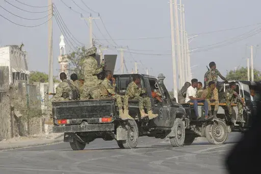 Security patrol the streets during fighting between al-Shabab extremists and soldiers in Mogadishu, Somalia, Tuesday, Feb. 21, 2023. Security forces in Somalia have ended a siege by al-Shabab extremists that killed and wounded a number of people at a home in the capital, Mogadishu. (AP Photo/Farah Abdi Warsameh)