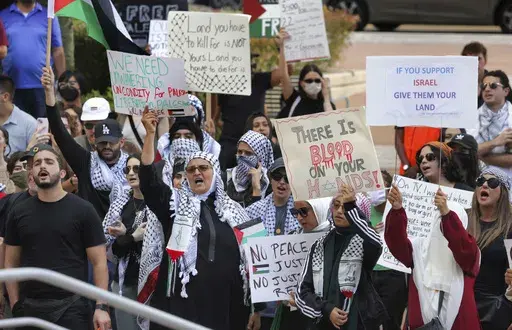 Pro-Palestinian supporters hold up signs during a demonstration at Orlando City Hall, Friday, Oct. 20, 2023, in Orlando, Fla. State lawmakers across the country are expected consider legislation related to the Israel-Hamas war in 2024. (Joe Burbank/Orlando Sentinel via AP, File)