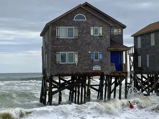 CORRECTS DATE This photo provided by Cape Hatteras National Seashore shows a house several hours before it collapsed into the ocean in Rodanthe, N.C., on Tuesday, Sept. 24, 2024. (Cape Hatteras National Seashore/National Park Service via AP)