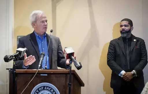 Ted Henifin, left, the City of Jackson water system third-party administrator, addresses media questions during a news conference at City Hall as Jackson Mayor Chokwe Antar Lumumba listens on Dec. 5, 2022, in Jackson, Miss. Henifin, the manager appointed by the U.S. Department of Justice to oversee reforms to the beleaguered water system in Mississippi’s capital city, says he won't have enough money to cover expenses until more federal funds arrive. (Barbara Gauntt/The Clarion-Ledger via AP, F