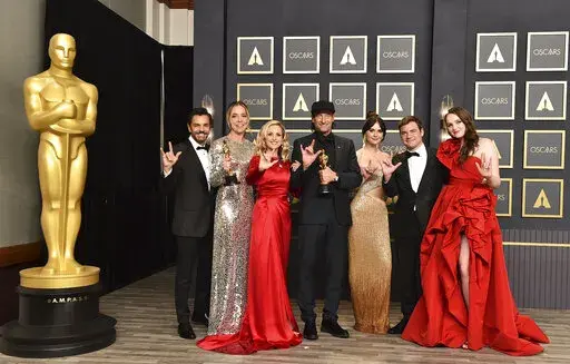 Eugenio Derbez, from left, Sian Heder, Marlee Matlin, Troy Kotsur, Emilia Jones, Daniel Durant and Amy Forsyth, winners of the award for best picture for "CODA," pose in the press room while signing "I love you" at the Oscars on March 27, 2022, at the Dolby Theatre in Los Angeles. The three Oscar wins for the film “CODA” has provided an unprecedented feeling of affirmation to people in the Deaf community.  (Photo by Jordan Strauss/Invision/AP, File)