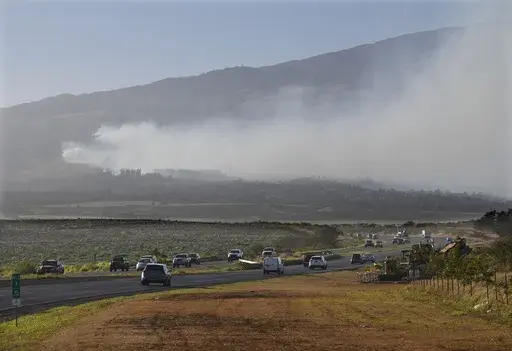 Smoke blows across the slope of Haleakala volcano on Maui, Hawaii, as a fire burns in Maui's upcountry region on Tuesday, Aug. 8. 2023. Several Hawaii communities were forced to evacuate from wildfires that destroyed at least two homes as of Tuesday as a dry season mixed with strong wind gusts made for dangerous fire conditions. (Matthew Thayer/The Maui News via AP)