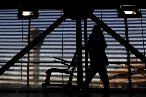 An airline employee transfers a wheelchair to her station at O'Hare International Airport in Chicago, Nov. 23, 2022. The Biden administration will propose Thursday, Feb. 29, 2024, to make it easier for the government to fine airlines for damaging or misplacing wheelchairs by making it an automatic violation of a federal law on accessible air travel. (AP Photo/Nam Y. Huh, File)