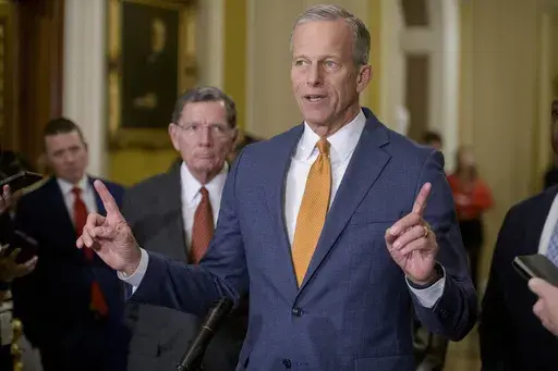 Sen. John Barrasso, R-Wyo., left, listens while Senate Majority Leader John Thune, R-S.D., speaks following the Senate Republican policy luncheon at the Capitol, Tuesday, Feb. 4, 2025, in Washington. (AP Photo/Rod Lamkey, Jr.)