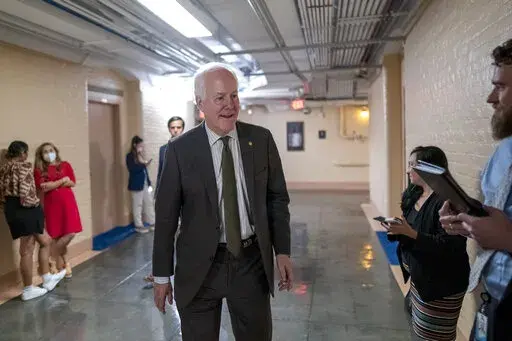 Sen. John Cornyn, R-Texas, arrives to meet with Sen. Chris Murphy, D-Conn., and Sen. Kyrsten Sinema, D-Ariz., arrive for more bipartisan talks on how to rein in gun violence, at the Capitol in Washington, Wednesday, June 15, 2022. Democratic and Republican negotiators have already reached a broad agreement but still need to convert that accord into legislation, in hopes that Congress could approve it before leaving for its July 4 recess. (AP Photo/J. Scott Applewhite)
