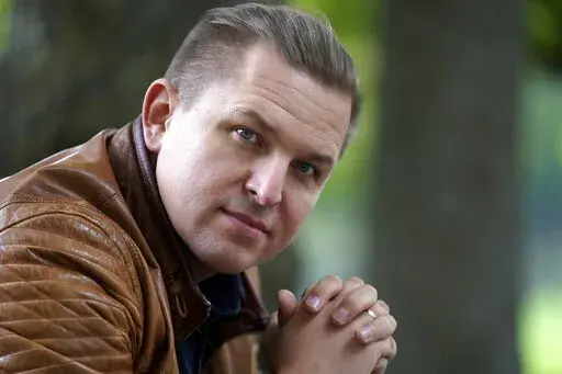 Opera singer Ilya Silchukou sits for a photograph at a park in a suburb of Boston, Tuesday, Oct. 4, 2022. Silchukou was a cultural icon in his native Belarus, the lead soloist at the State Opera Bolshoi who represented his nation at official government functions at home and abroad and performed at opera houses all over Europe. He lived a privileged and comfortable life in his homeland, but gave it up after joining tens of thousands of Belarusians at election protests that were violently suppress