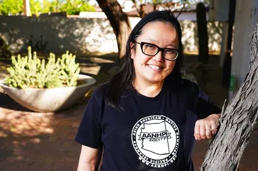 Jennifer Chau, director of the Arizona Asian American Native Hawaiian and Pacific Islander For Equity Coalition, at her office Friday, April 8, 2022, in Tempe, Ariz. (AP Photo/Ross D. Franklin)