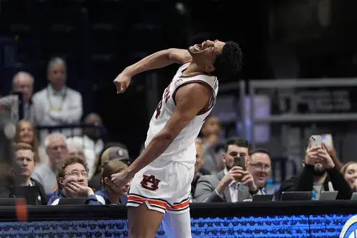 Auburn center Dylan Cardwell (44) reacts after scoring during the second half of an NCAA college basketball game against Mississippi State in the semifinal round of the Southeastern Conference tournament, Saturday, March 16, 2024, in Nashville, Tenn. (AP Photo/John Bazemore)