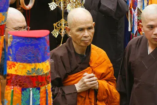 Vietnamese Zen master Thich Nhat Hanh, center, arrives for a great chanting ceremony at Vinh Nghiem Pagoda in Ho Chi Minh City, Vietnam on March 16, 2007. Zen Buddhist monk Thich Nhat Hanh, who helped pioneer the concept of mindfulness in the West and socially engaged Buddhism in the East, has died at age 95 on Saturday, Jan. 22, 2022, according to an announcement on his verified Twitter page. (AP Photo, File)