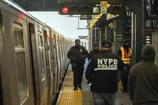Police officers patrol the F train platform at the Coney Island-Stillwell Avenue Station, Thursday, Dec. 26, 2024, in New York. (AP Photo/Yuki Iwamura, File)