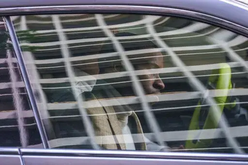 Daystar Peterson, the rap artist known as Tory Lanez, 30, sits in the passenger seat of a sport car as he's driven away from the Clara Shortridge Foltz Criminal Justice Center Tuesday, Dec. 13, 2022, in Los Angeles. Lanez is free on bail after being charged with felony assault for allegedly shooting rapper Megan Thee Stallion in the feet. (AP Photo/Damian Dovarganes)
